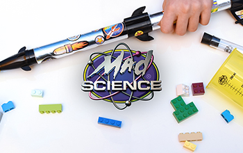 A Mad Science toy rocket ship next to a Mad Science logo